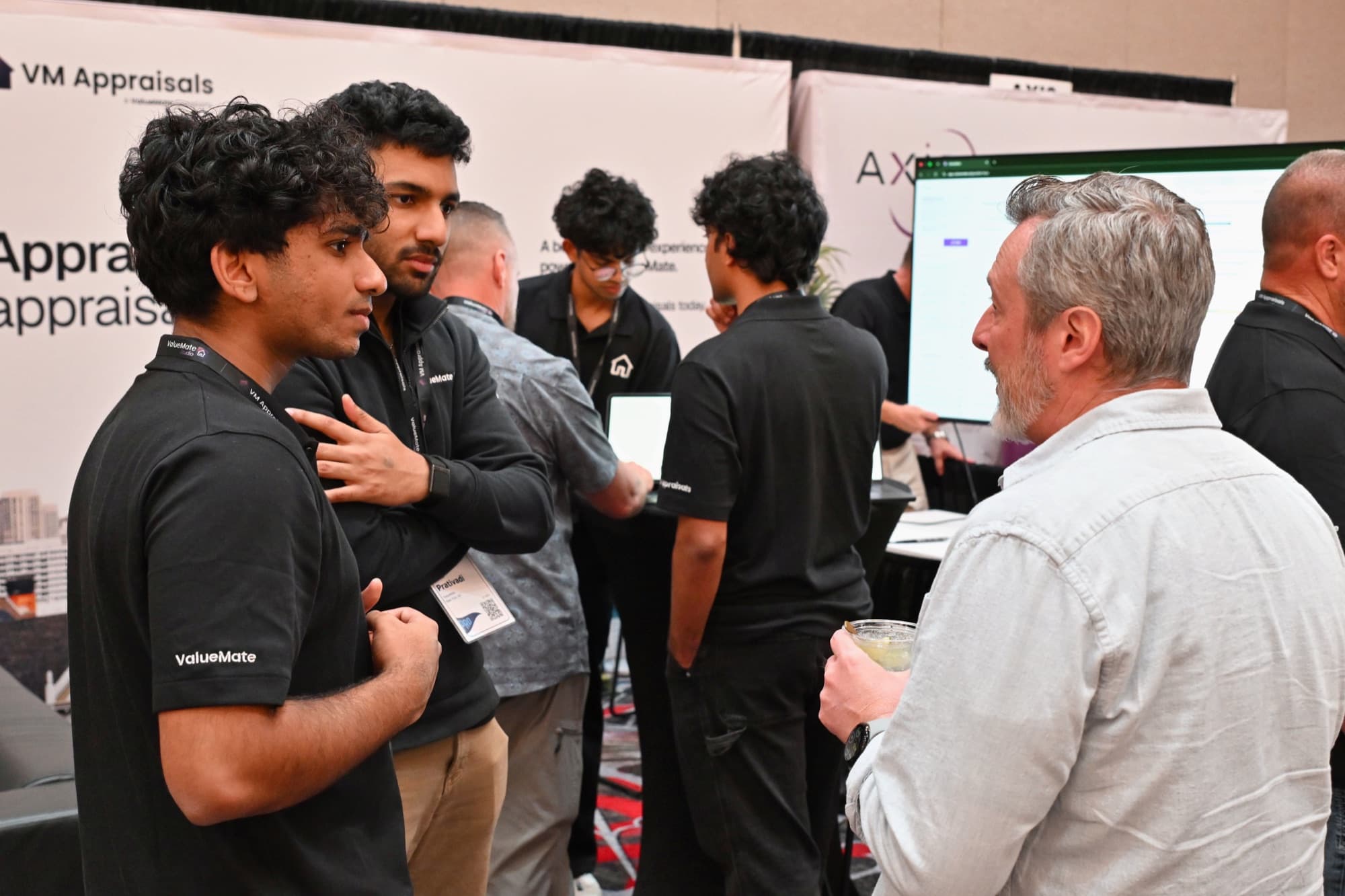 The ValueMate team demonstrating ValueMate Studio at the conference booth