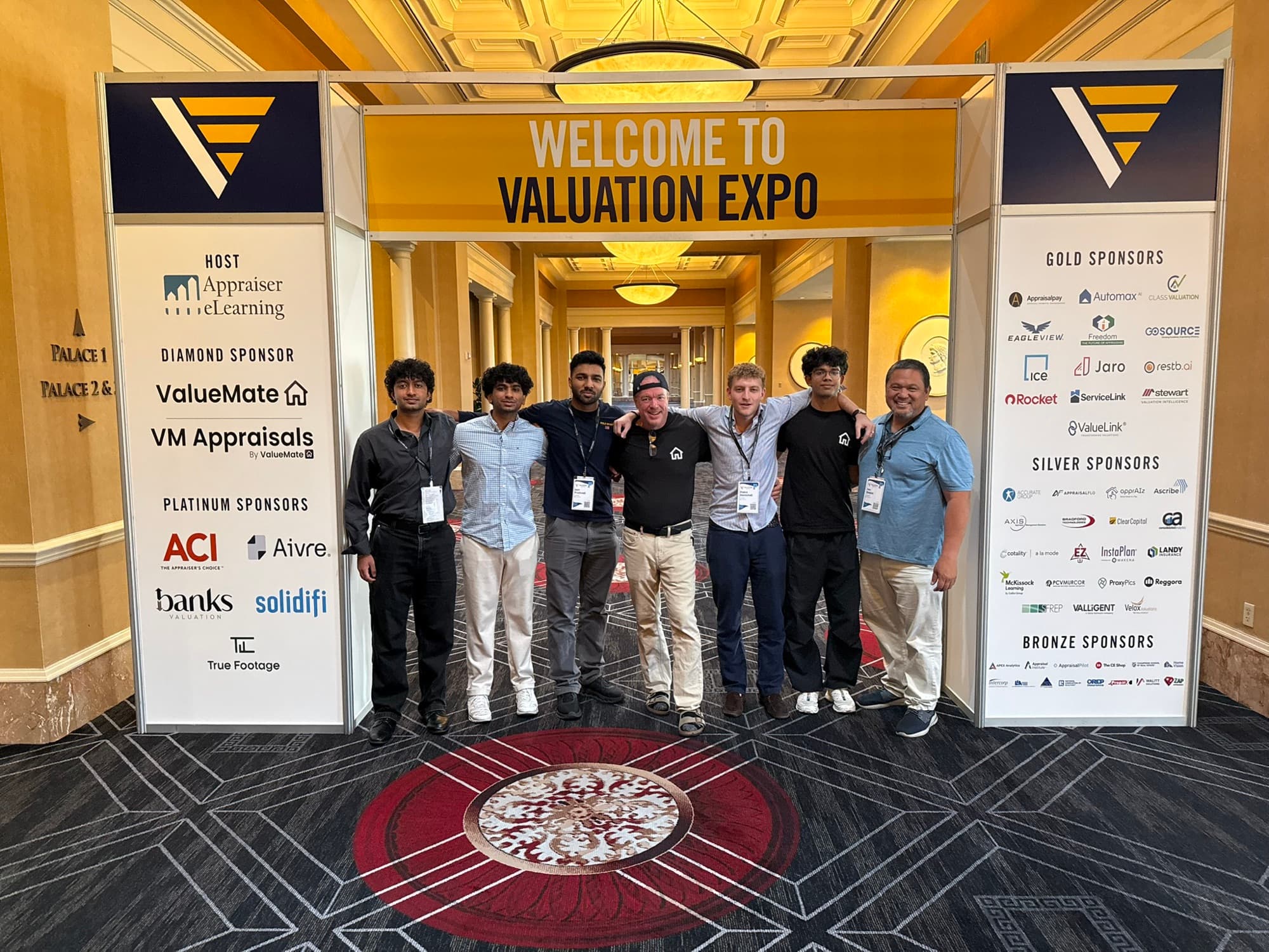 The ValueMate and VM Appraisals team beneath the Valuation Expo entrance sign